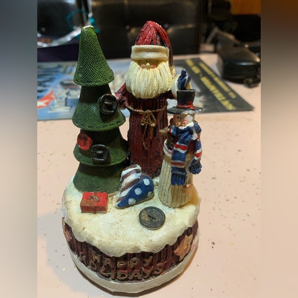 style holiday figurine featuring Santa Claus and a snowman